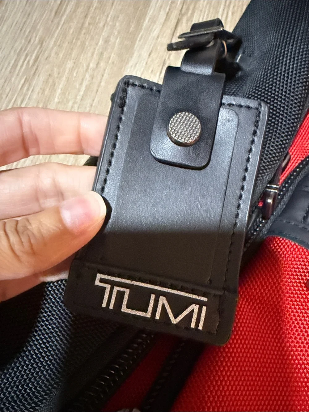 Tumi Red and Black Men/Women’s Backpack with Multiple Front Pockets